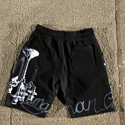 Black shorts with white graphics on a textured surface